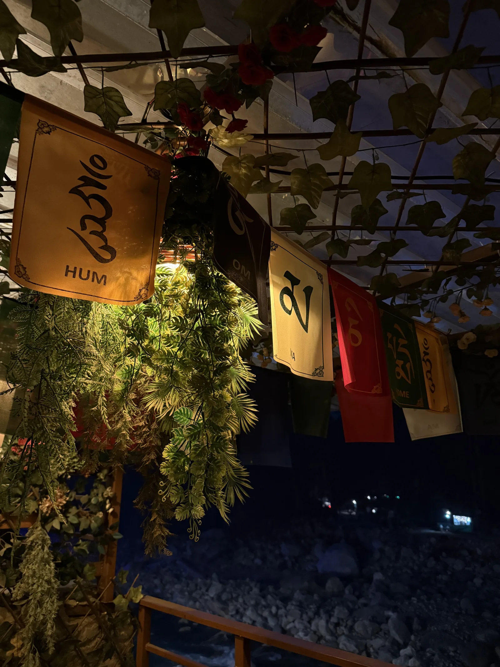 Kasol, Prayer flags at a riverside cafe after dark